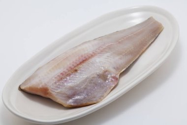 Beyaz arka planda tabakta çiğ balık