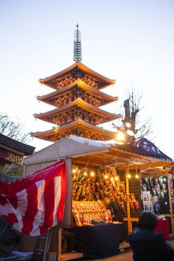 Hagoita Ichi Winter Festival at Sensoji Temple in Asakusa, Japan. Asakusa's annual year-end Hagoita Fair is a colorful and exciting traditional event. clipart