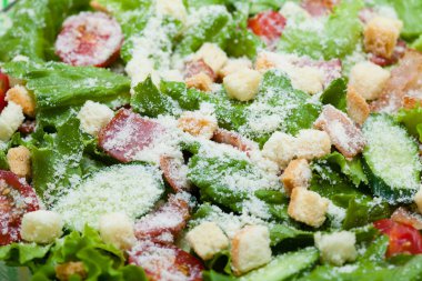 Tabakta kızarmış ekmek ve peynirli taze sezar salatası.