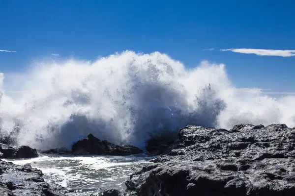 stock image view of the beautiful rocky beach on a stormy day, waves shuttering at the shore 