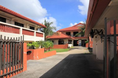 Kırmızı kiremit çatılı tropikal binalar arasındaki güneşli avlu