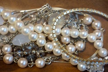 Parlak inci kolyeler Parlak gümüş bilezikler arasında