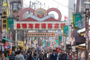 Tokyo, Japonya 'da insanlar caddenin ortasında yavaşça yürüyorlar..