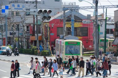 Tokyo, Japonya 'da insanlar caddenin ortasında yavaşça yürüyorlar..