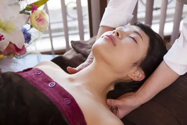 asian woman getting spa facial massage.