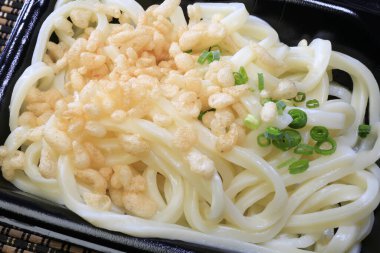 Serving delicious udon noodles topped with tempura