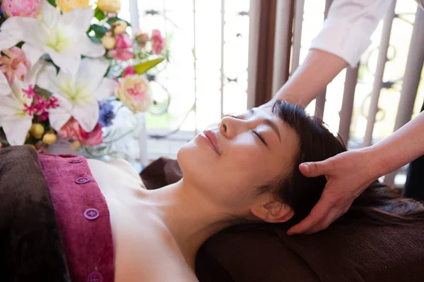 asian woman getting spa facial massage.