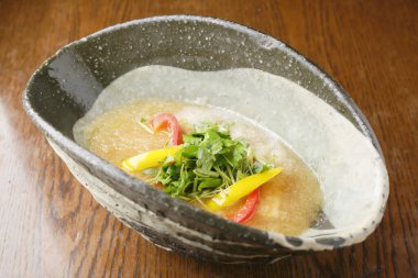 Renkli sebzeler kırsal seramik kasede taze çorba süslüyor.