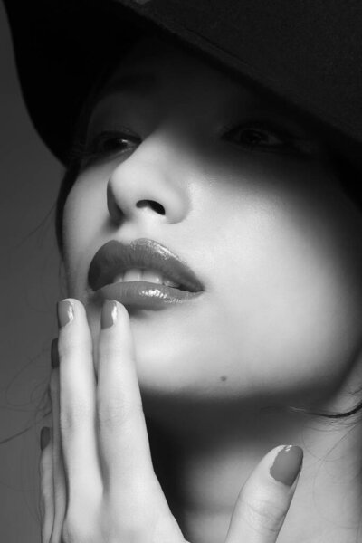 Portrait of young beautiful asian woman in a hat