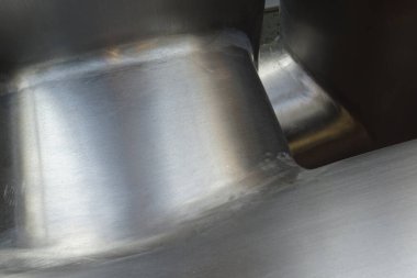 Shiny metallic surface reflecting light at close angle