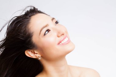 Güzel Asyalı genç kadın gülümsüyor.