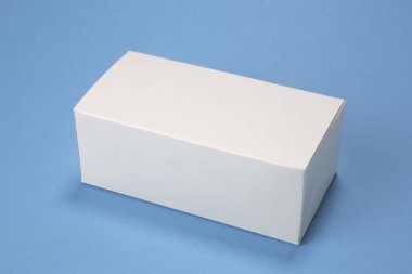 Plain white rectangular box resting against blue background