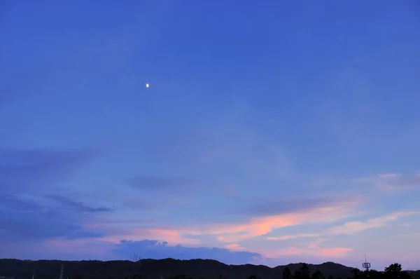 beautiful sunset sky with moon and clouds, nature background