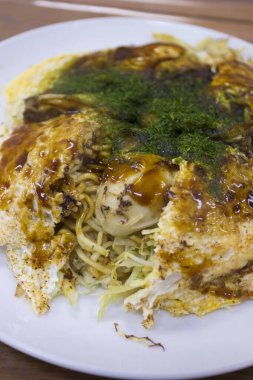 Serving delicious japanese okonomiyaki dish
