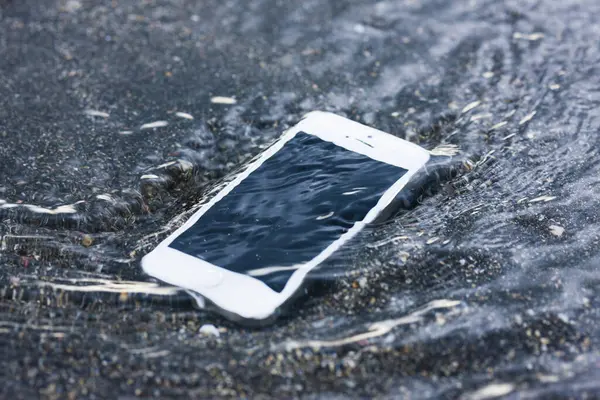 phone under water on the beach