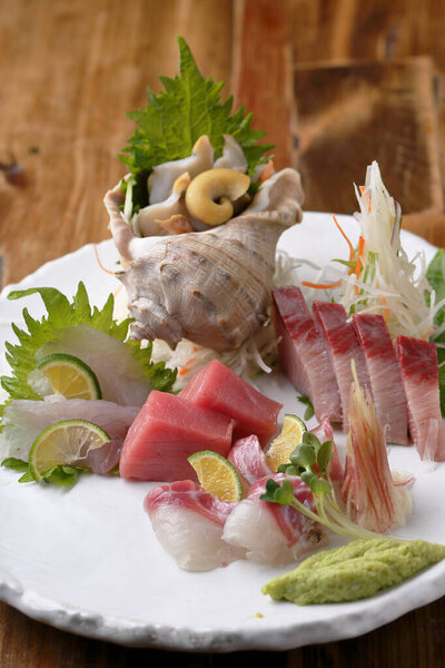 Fresh seafood served on plate, japanese cuisine concept, closeup shot 