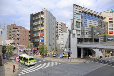 Güneş ışığı, çeşitli Japon şehir binalarının dokularını ve karmaşık detaylarını vurgular..