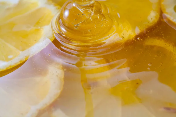 Close up view of honey with lemon slices. Macro photography