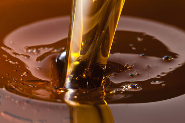 Close up view of pouring honey. Macro photography