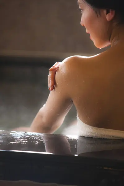 asian woman relaxing at hot springs in Japan