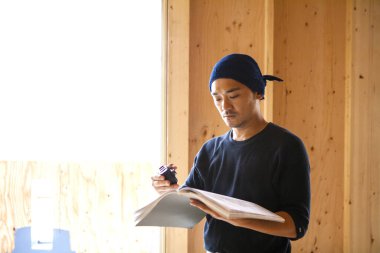 İnşaatta çalışan genç Asyalı marangozun portresi