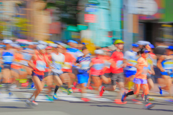 Blurred background of marathon runners in city