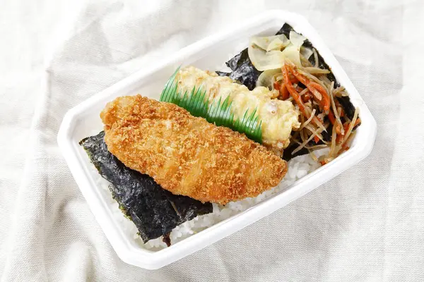lunch box with fried fish and noodles in Japanese style