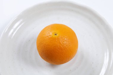 Tüm portakalı beyaz bir tabakta