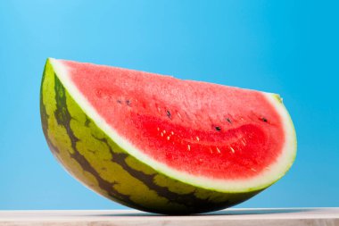 Mavi arka planda taze olgun karpuzun yakın görüntüsü