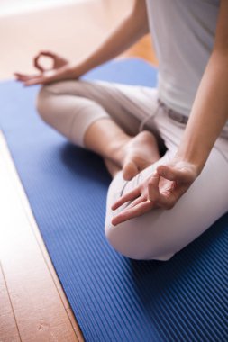  Nilüfer pozisyonunda meditasyon yapan kadın, ellerin yakın çekimi, Gyan Mudra ve Lotus pozisyonu