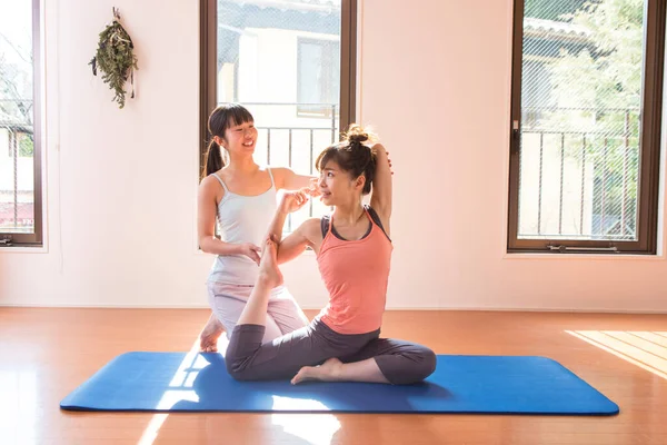 young asian women exercising together at home in living room