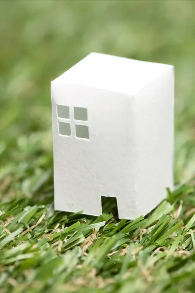 house model in green grass. real estate concept. house model