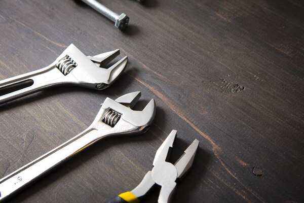 wrenches on wooden background, construction and building concept background