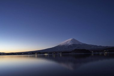 Gün batımında dağları olan güzel göl manzarası