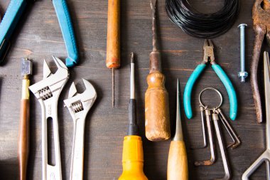 set of different tools on a wooden background. top view