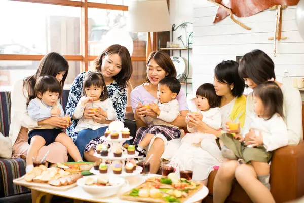 stock image japanese women with children sitting at table with food. Celebration concept