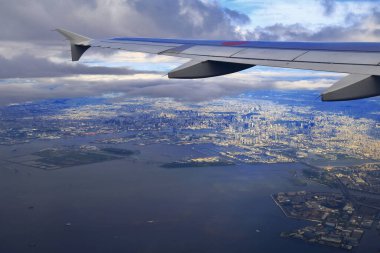 Deniz ve şehrin üzerinde uçan bir uçağın güzel manzarası.