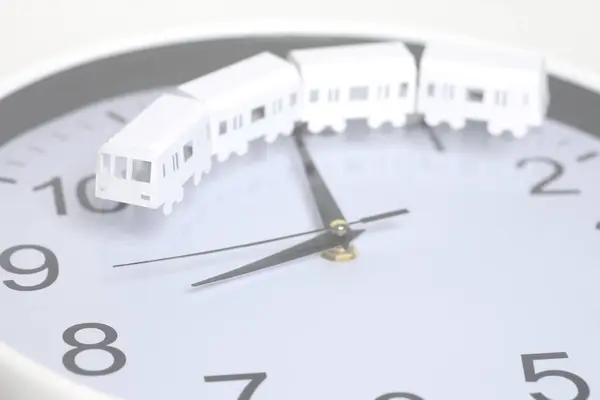 Cut out paper train isolated on clock background