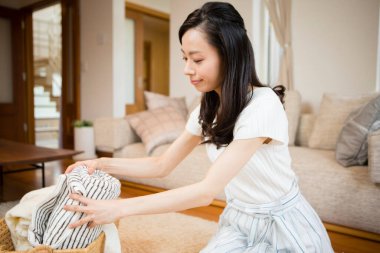 Güzel genç bayan evde çamaşır yıkıyor. 