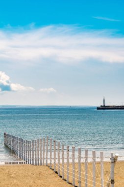 Çit, mavi deniz ve güzel sahil.