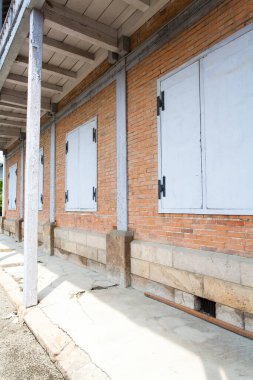 shuttered windows of old Tomioka Silk Mill in Gunma, Japan. UNESCO World Heritage site clipart