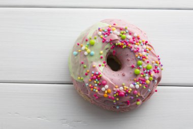 Pembe kremalı ve şekerli donutu kapat.