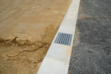 Drainage grate installed on concrete edge of construction site