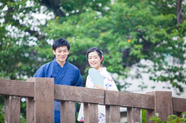 Genç Japon çift yaz parkında geleneksel kimono giyiyor.