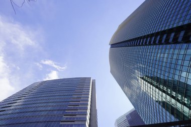 Modern şehir mimarisi, Tokyo, Japonya. Gökdelenler mavi gökyüzüne karşı güneşli bir günde 