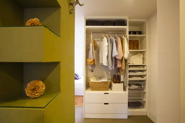 a closet with a shelf and a drawer