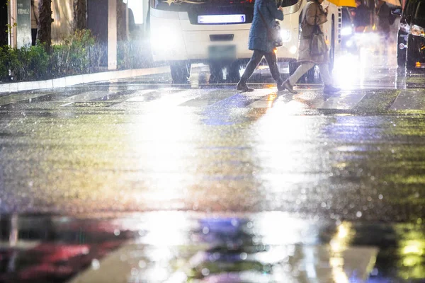 rain drops on pavement at night