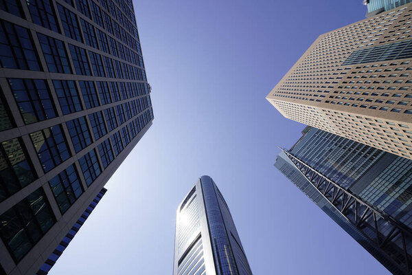 Modern city architecture, Tokyo, Japan. Skyscrapers against blue sky on a sunny day