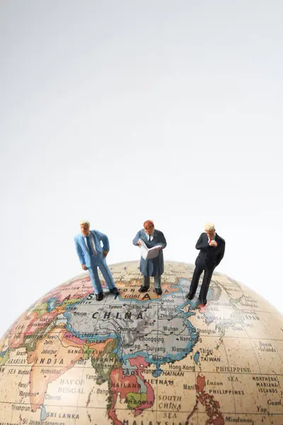 Miniature People Figurines Standing Top Earth Globe Model White Background — Stock Photo, Image