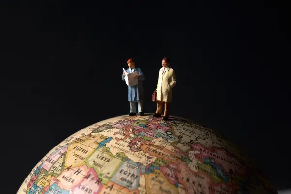 Miniature People Figurines Standing Top Earth Globe Model Black Background — Stock Photo, Image